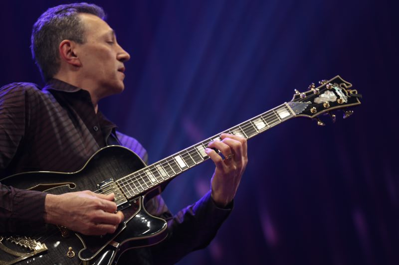 Vinny Valentino playing guitar on stage